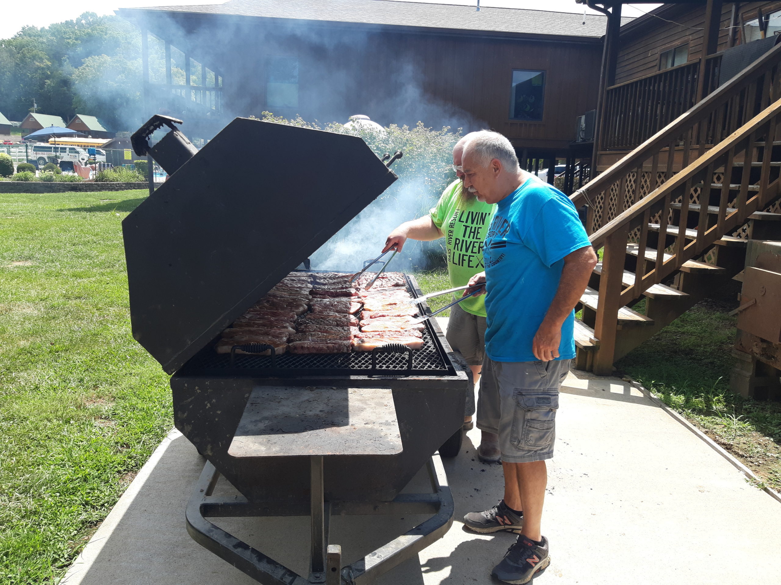 Man grilling chicken on a large grill