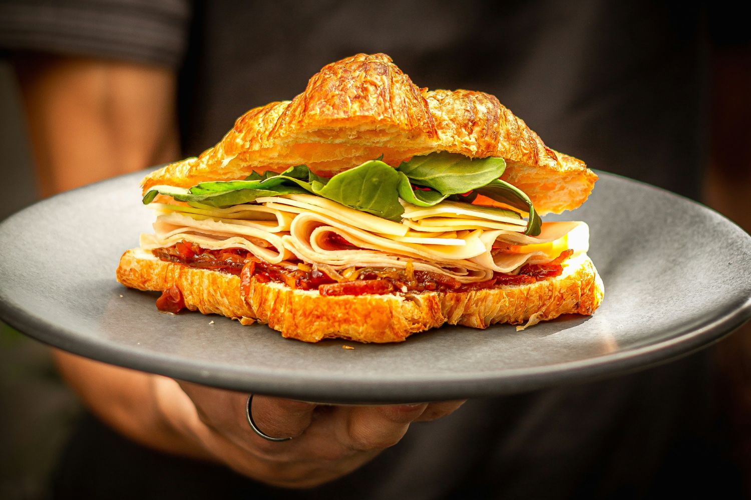 A croissant with ham and cheese