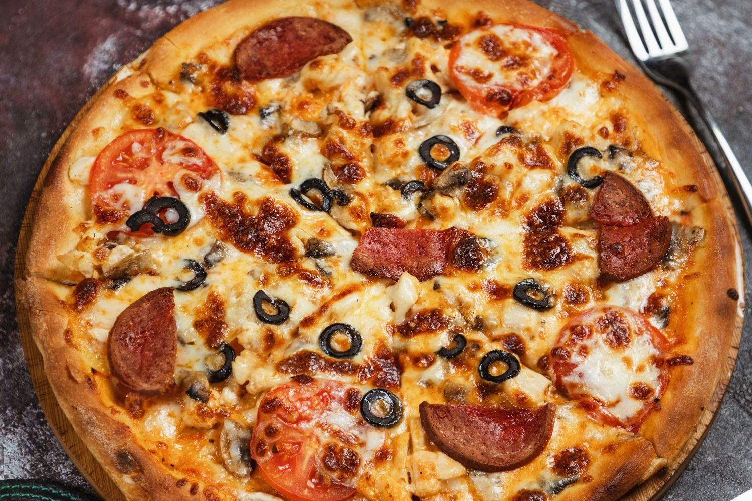 A large pizza with pepperoni and olives